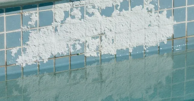 Pool technician examining a corroded salt cell from a saltwater pool system